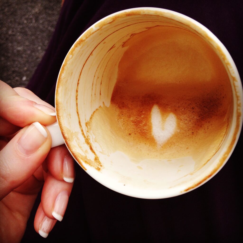 Empty cup of cappuccino with a heart in the foam