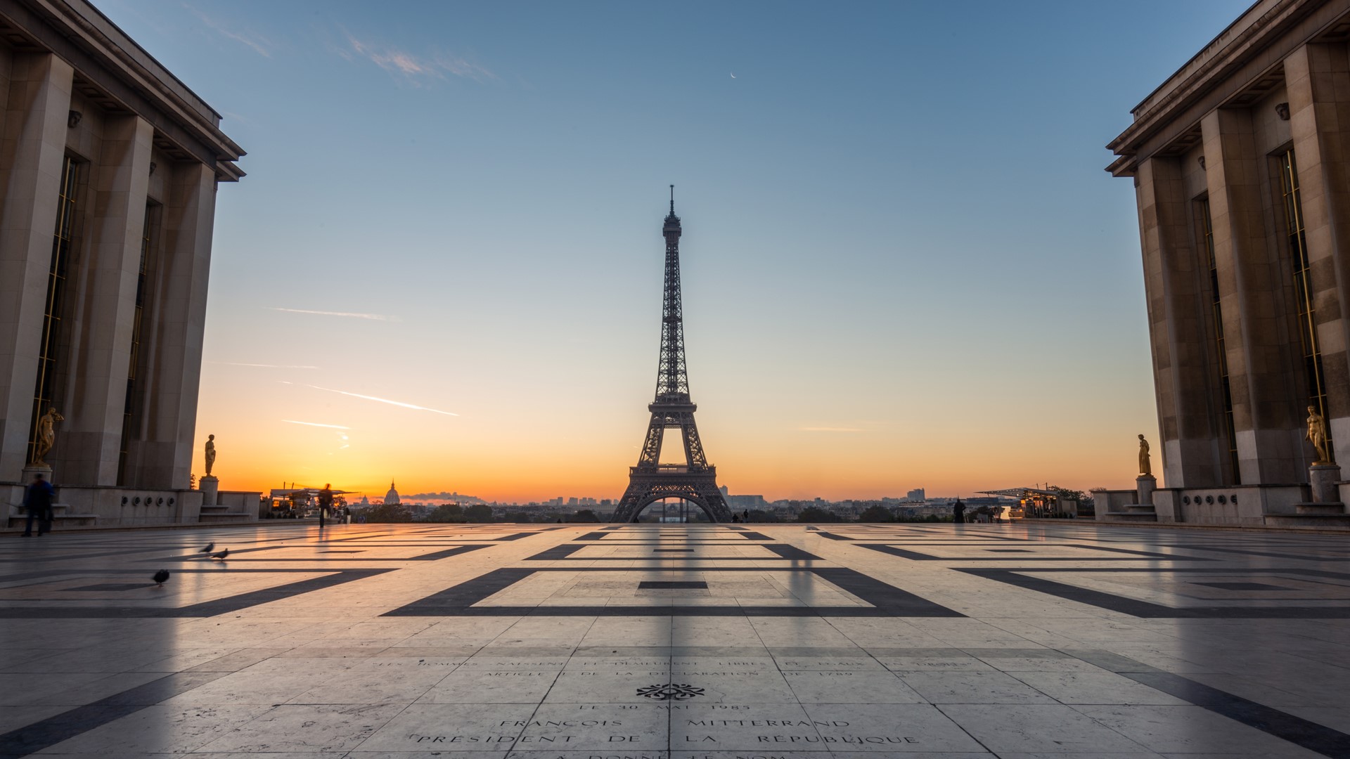 Image of the Eiffel Tower from a distance with a stunning sunset behind it