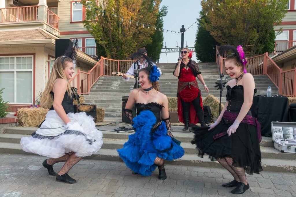 Saloon girls dancing to live musicians singing "Twist & Shout" by The Beatles