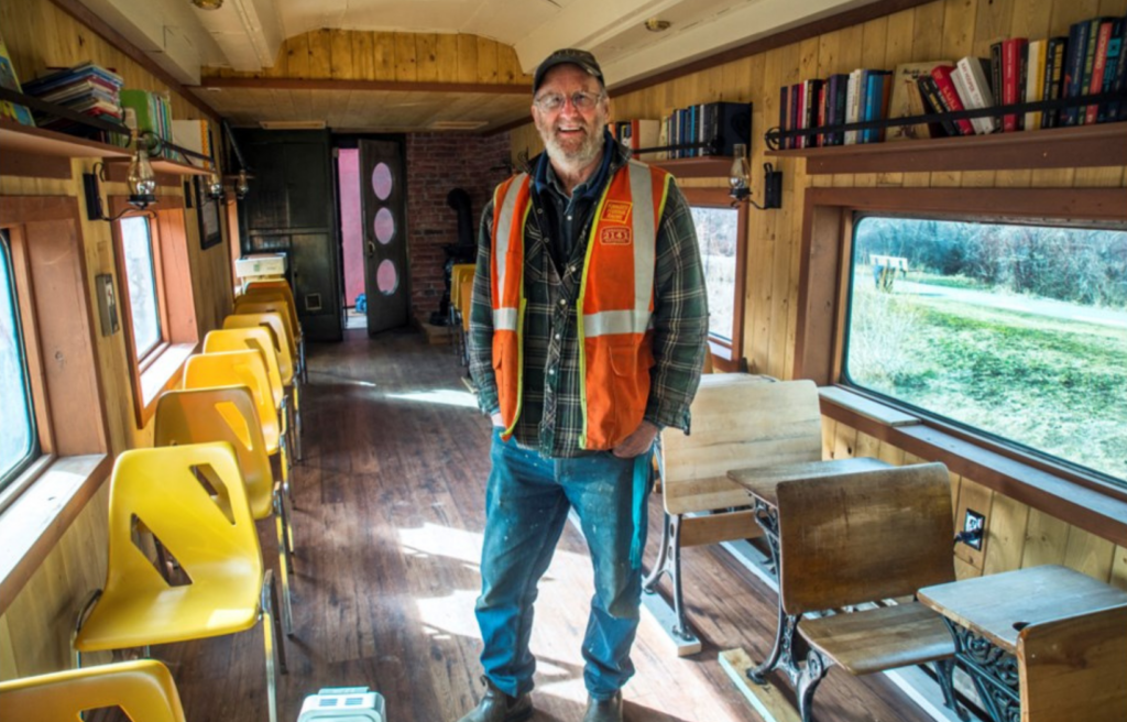 President Normal Glass standing in the newly renovated classroom car